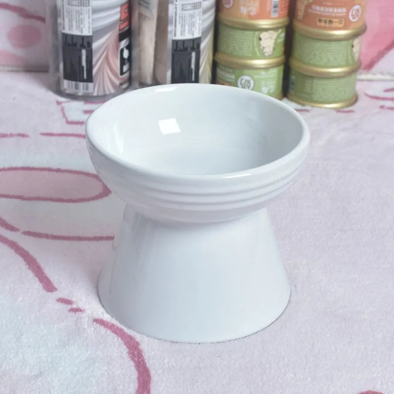 A white ceramic pet bowl with a high foot and raised neck protector to prevent tipping.