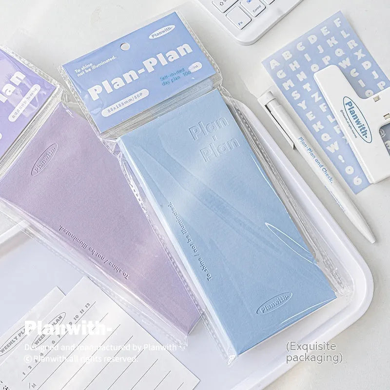 Embossed cover daily meter book notebook open on a desk, showing white 100g paper.