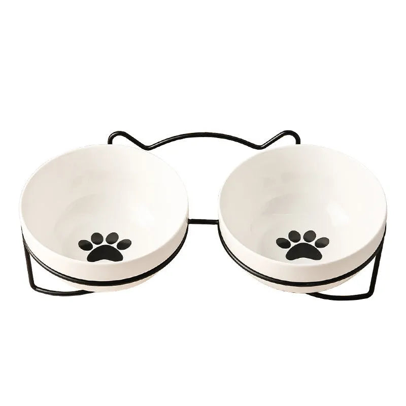 Ceramic cat bowl with iron frame stand showing cat paw print pattern and gold metal finish