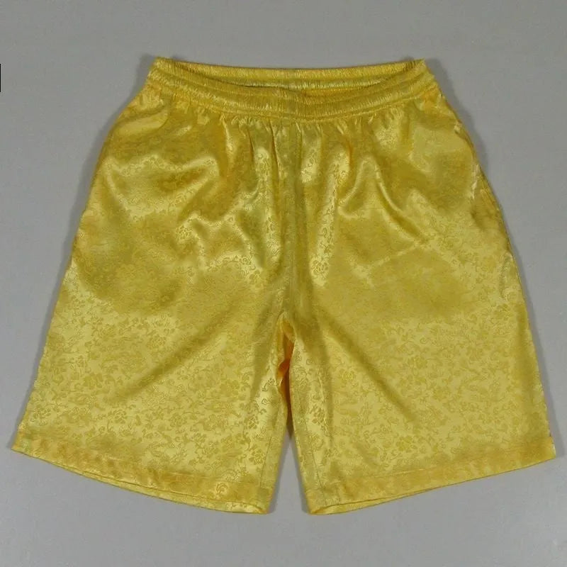 Men's black Tang Suit Tai Chi shorts with a white drawstring elastic waistband laid flat.