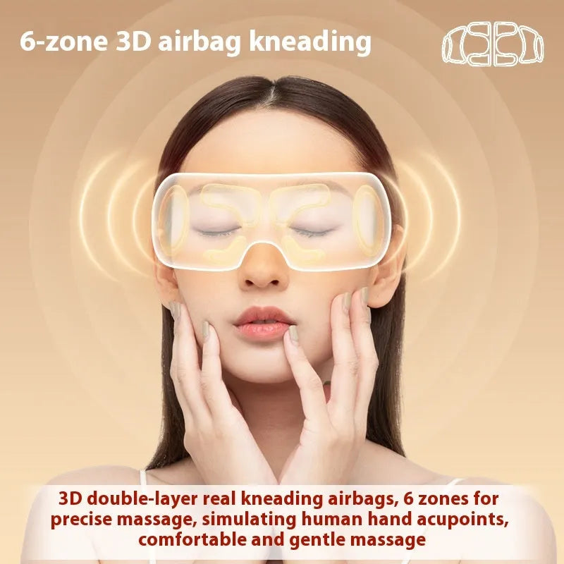 White portable electric eye massager with hot compress and airbag massage functions on a plain background