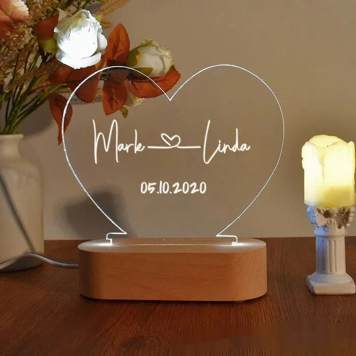 Custom engraved acrylic LED night light showing illuminated personal names and dates