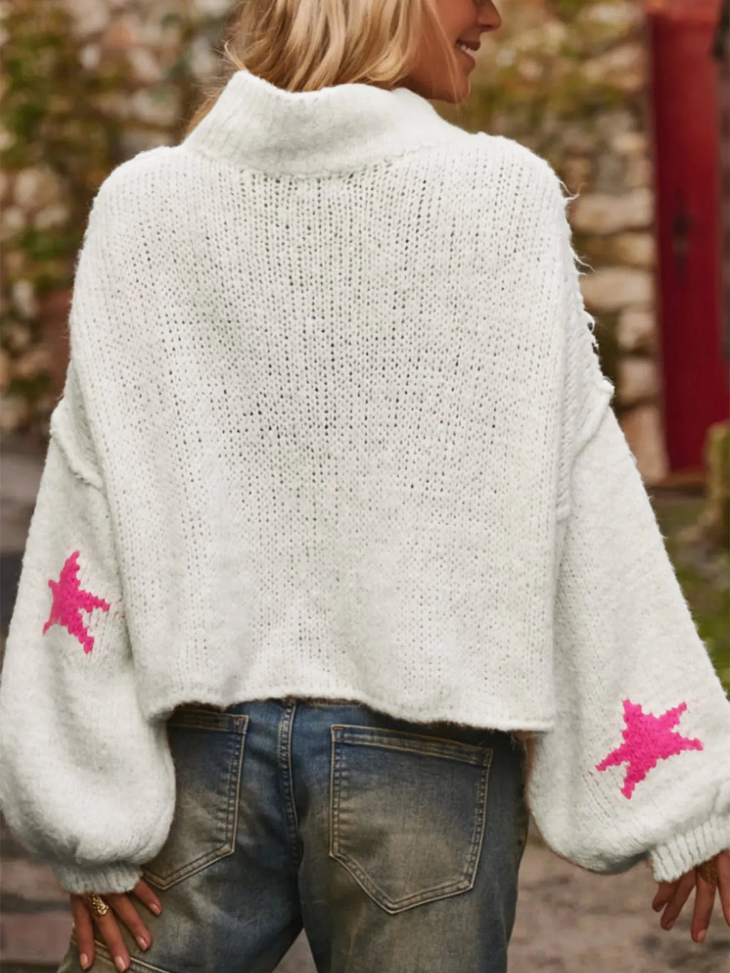 White women's loose fit turtleneck pullover with five-pointed star pattern detail