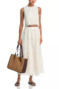 White women's sleeveless top and long skirt suit with retro embroidery detail on polyester fabric