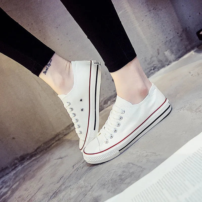 Solid colour canvas shoes for women on a plain background, showing the casual low-top design.