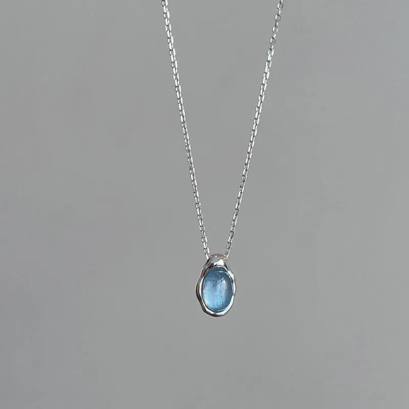 Navy blue water drop pendant necklace with geometric copper design on cross chain