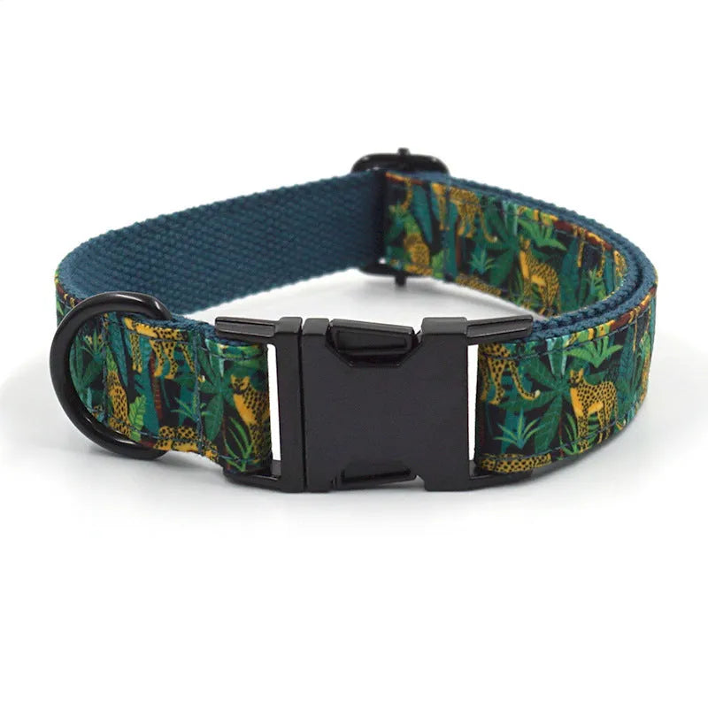 Green cloth pet collar and leash set with bowknot print on a white background showing collar and leash together