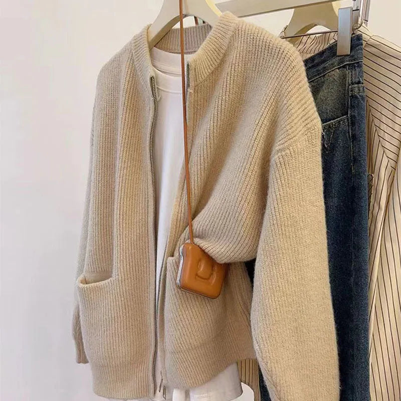 Beige viscose fibre soft wind cardigan coat with long sleeves on a hanger.