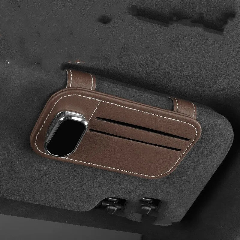 Cowhide leather card holder clipped onto a car sun visor in a choice of colours.