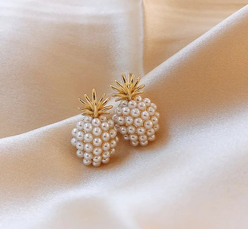 Gold Korean-style alloy earrings with pineapple starfish design and pearl-coloured gem inlays.