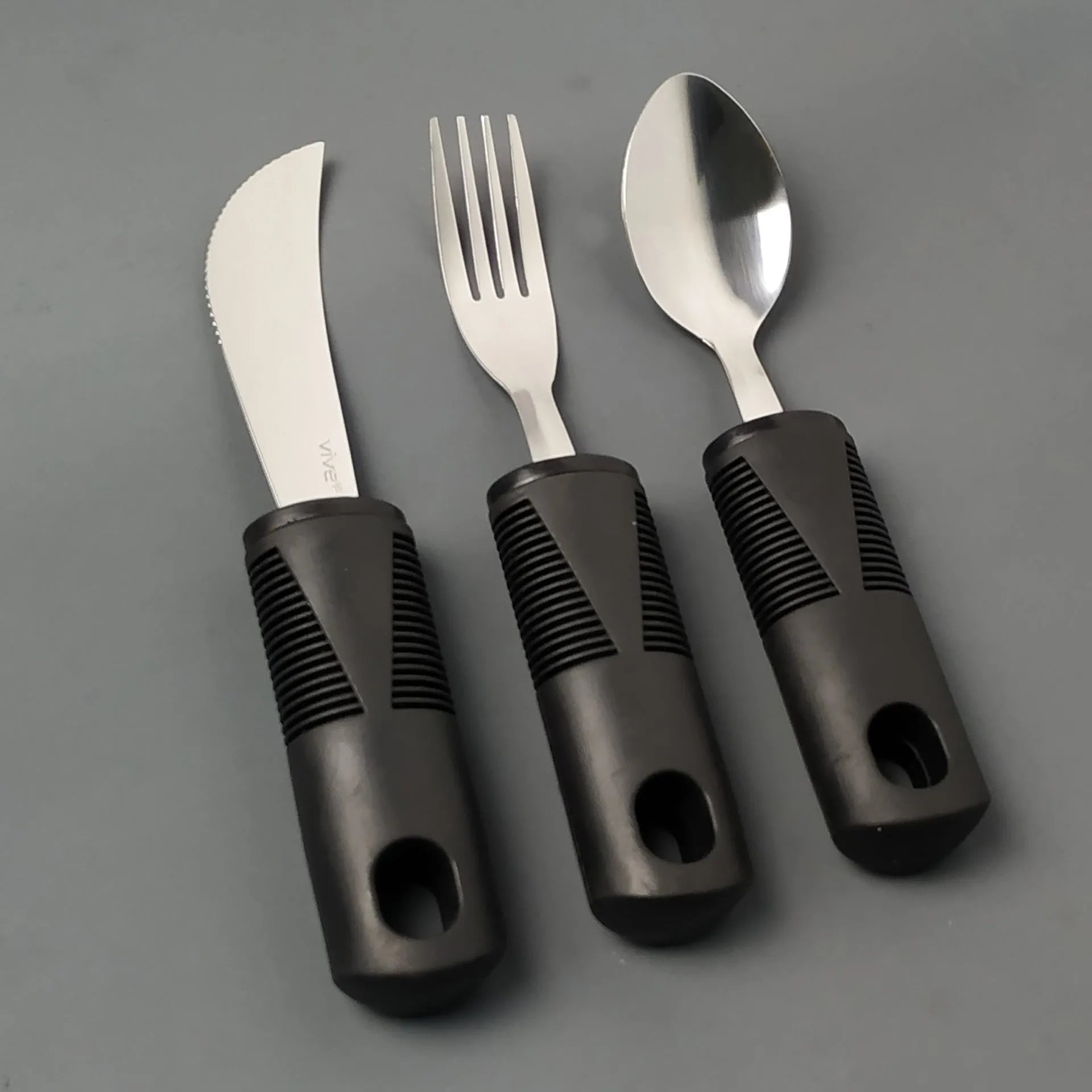 Stainless steel adaptive tableware with rubber handles in black and grey curved and straight designs