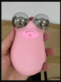 Pink or white HS-858 micro current facial lifting and firming device measuring 106mm by 65mm.