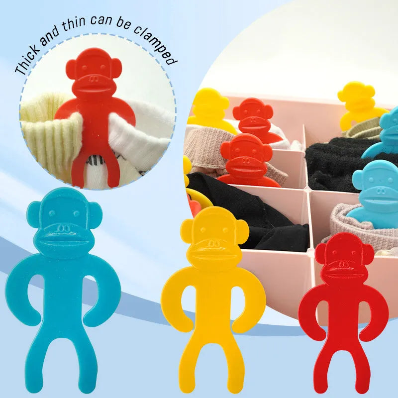 Plastic socks clips in blue, yellow and red colours for laundry organisation