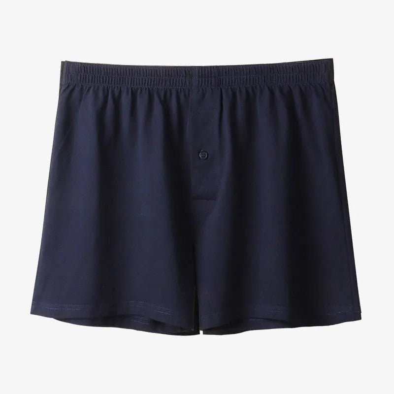Men's solid-colour cotton boxer shorts with a high-waist, loose fit on a neutral background.