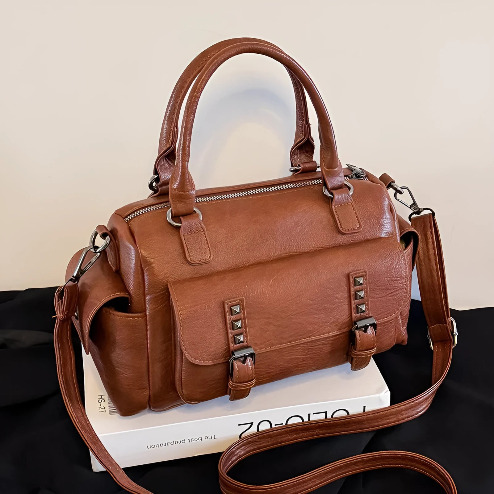 Vintage messenger bag in horizontal square shape showing contrast stitching details and shoulder strap