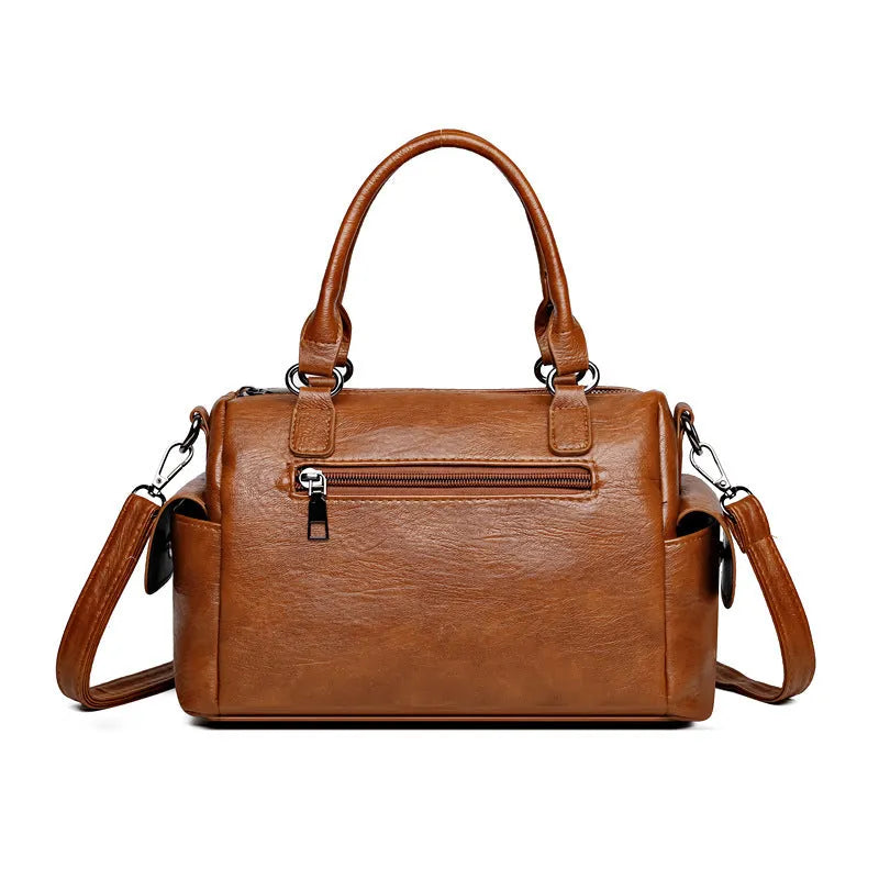 Vintage messenger bag in horizontal square shape showing contrast stitching details and shoulder strap