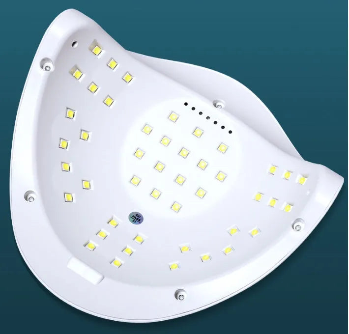 White nail polish dryer lamp with UV and LED light beads and digital timer display.