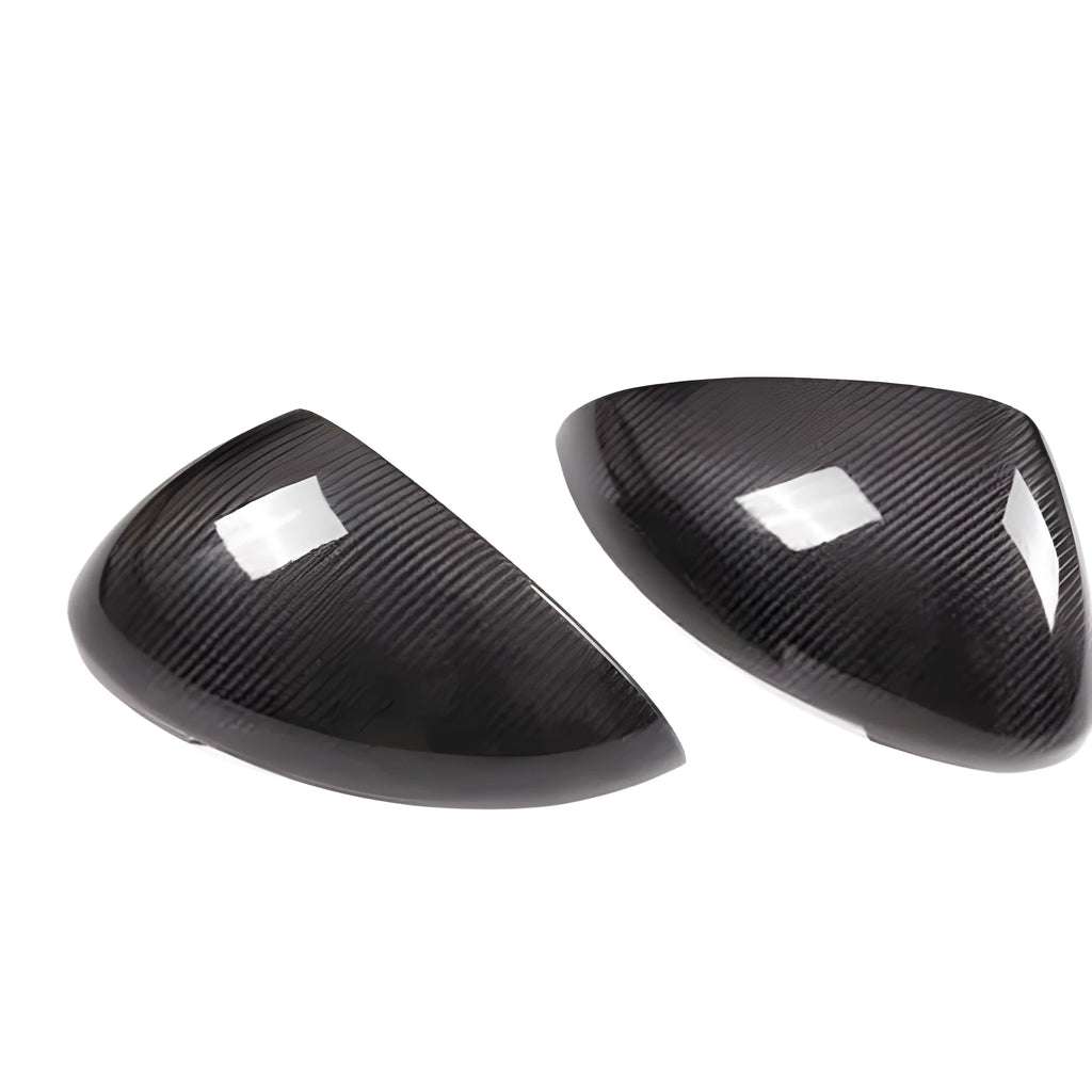 Black true carbon fibre rearview mirror cover for Porsche Macan on a white background