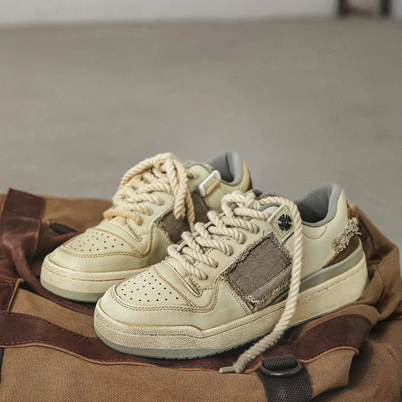 Beige low-top casual skate shoes with lace-up front and flat rubber sole.