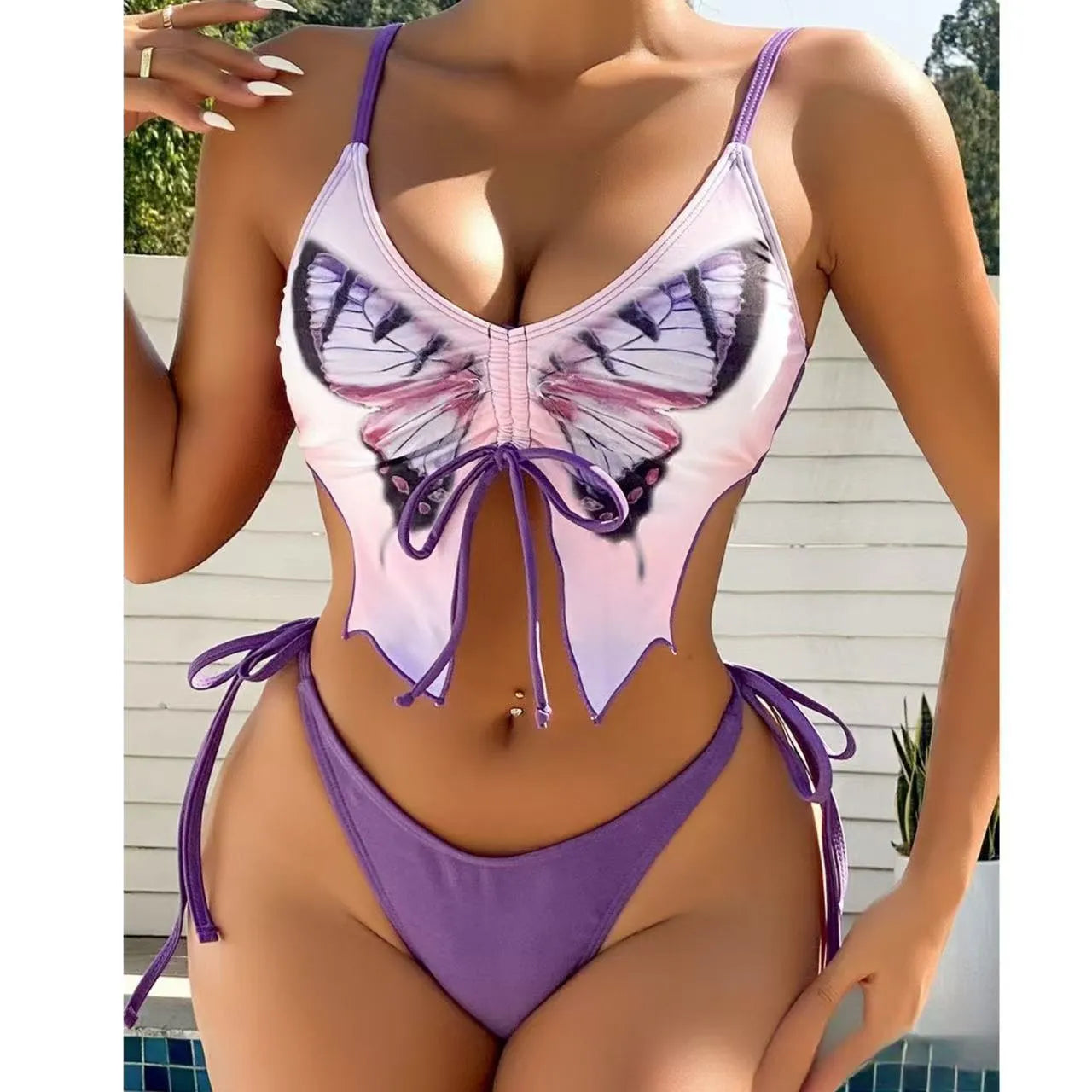Women's purple bow style split bikini swimsuit with sleeveless top and briefs.