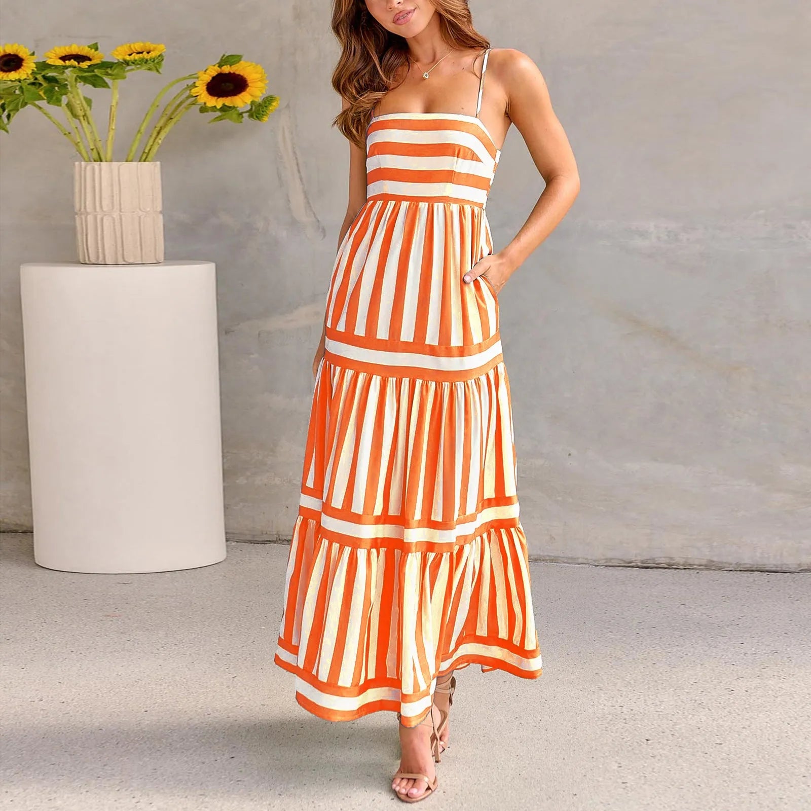 Women's long striped summer dress with suspenders, a square neckline, backless design, and side pockets.