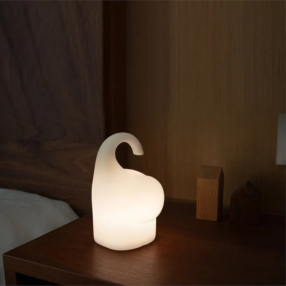 DOMI Elephant-shaped silicone night light with soft white glow on a bedside table