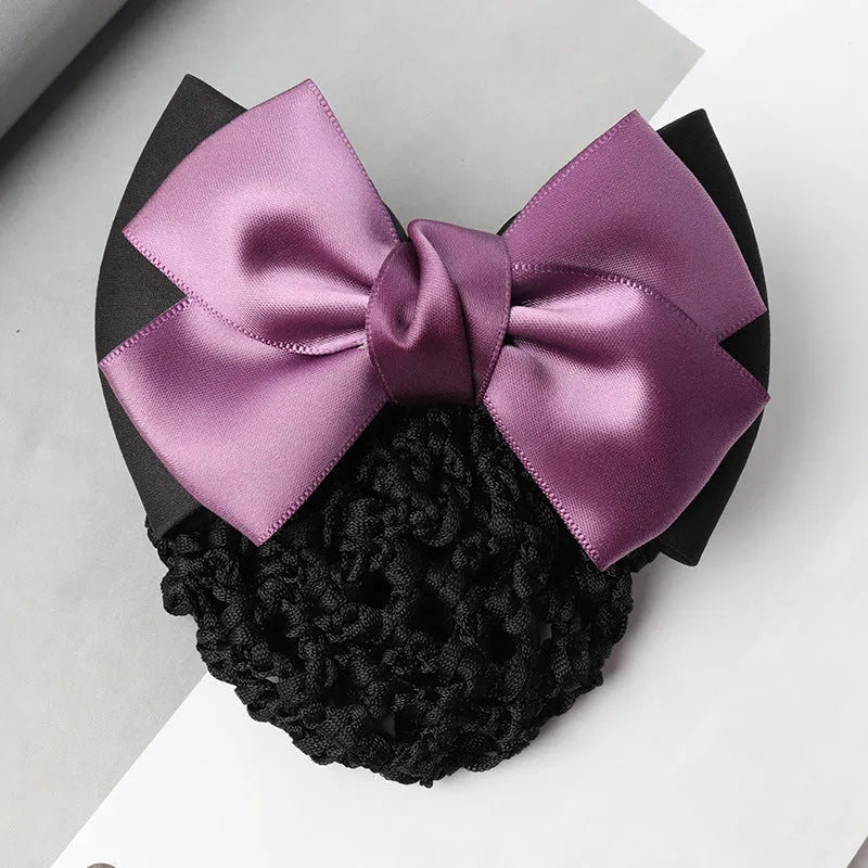 Professional hair clip with a black net pocket and a red flower bow ornament on a white background.