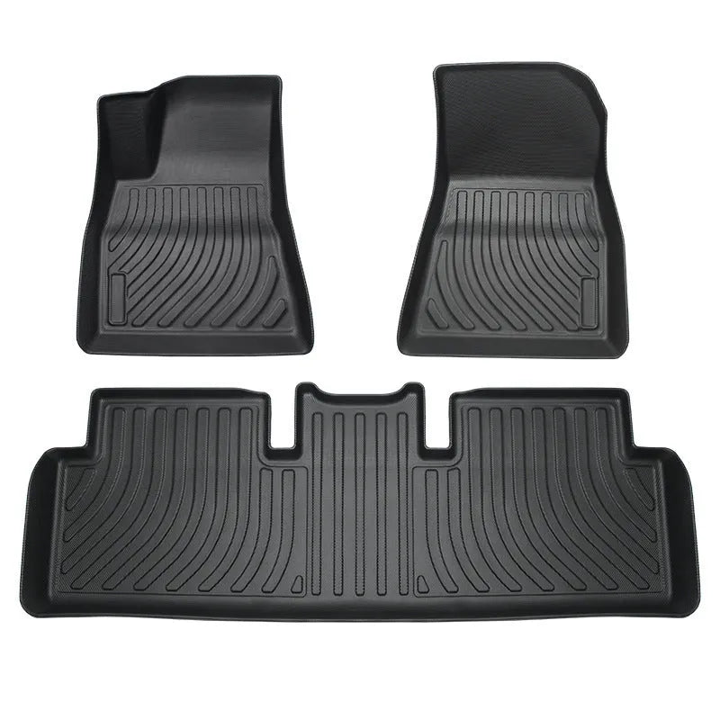Custom rubber floor mats for Tesla cars with a textured TPE driver footrest section.