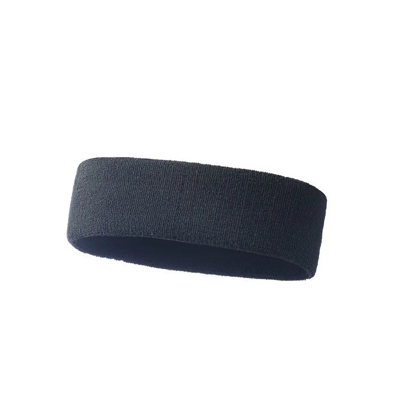 Elastic solid colour sports sweat band in black, shown on a forehead.