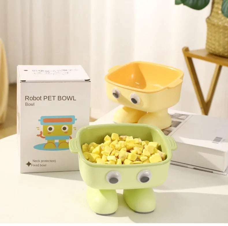 Green robot-shaped elevated cat bowl with tilted dish and anti-slip base.