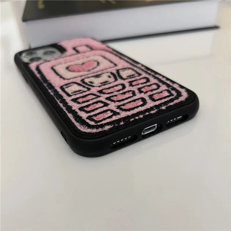 Soft pink TPU iPhone case with a towel-like embroidered texture on the back.