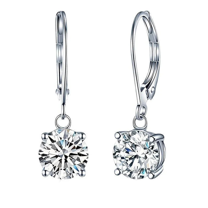 Silver-toned cubic zirconia stud earrings with 4mm round stone in claw setting on white background
