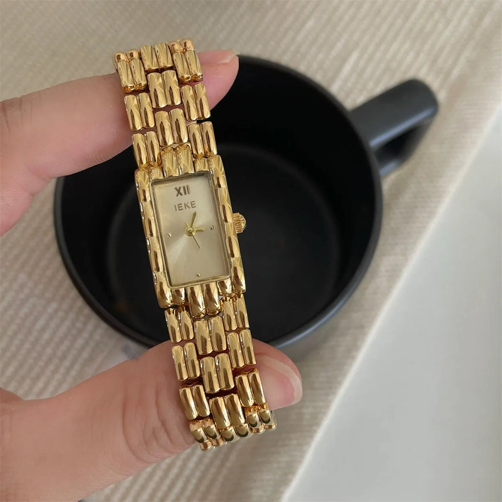 Women's vintage bracelet watch with a small dial, butterfly buckle, on a silver strap.