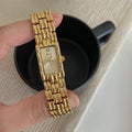 Women's vintage bracelet watch with a small dial, butterfly buckle, on a silver strap.