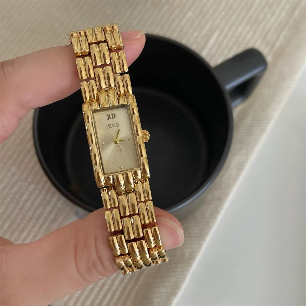 Women's vintage bracelet watch with a small dial, butterfly buckle, on a silver strap.