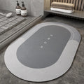Blended fabric bathroom floor mat in blue colour, shown in an oval shape on a tiled floor.