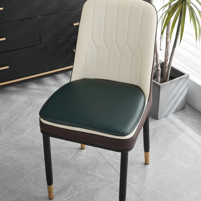 Horseshoe-shaped PU leather seat cushion in orange, shown on a chair.