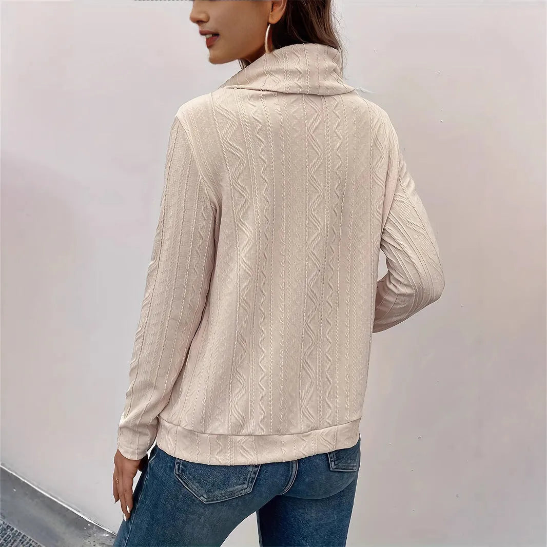 Apricot coloured pullover sweater with a drawstring hood and long sleeves laid flat.