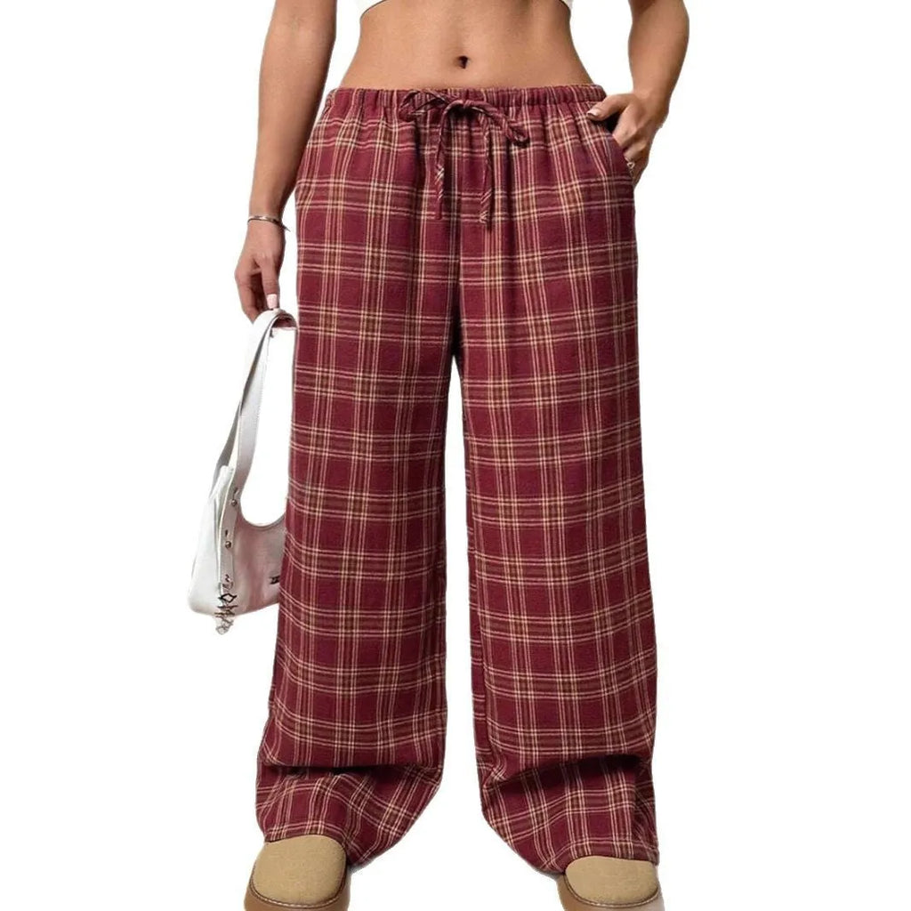 Women's red plaid loose trousers with drawstring waist and side pockets laid flat