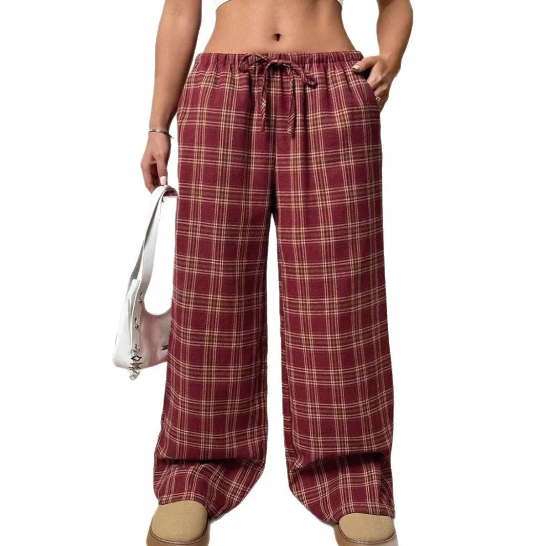 Women's red plaid loose trousers with drawstring waist and side pockets laid flat