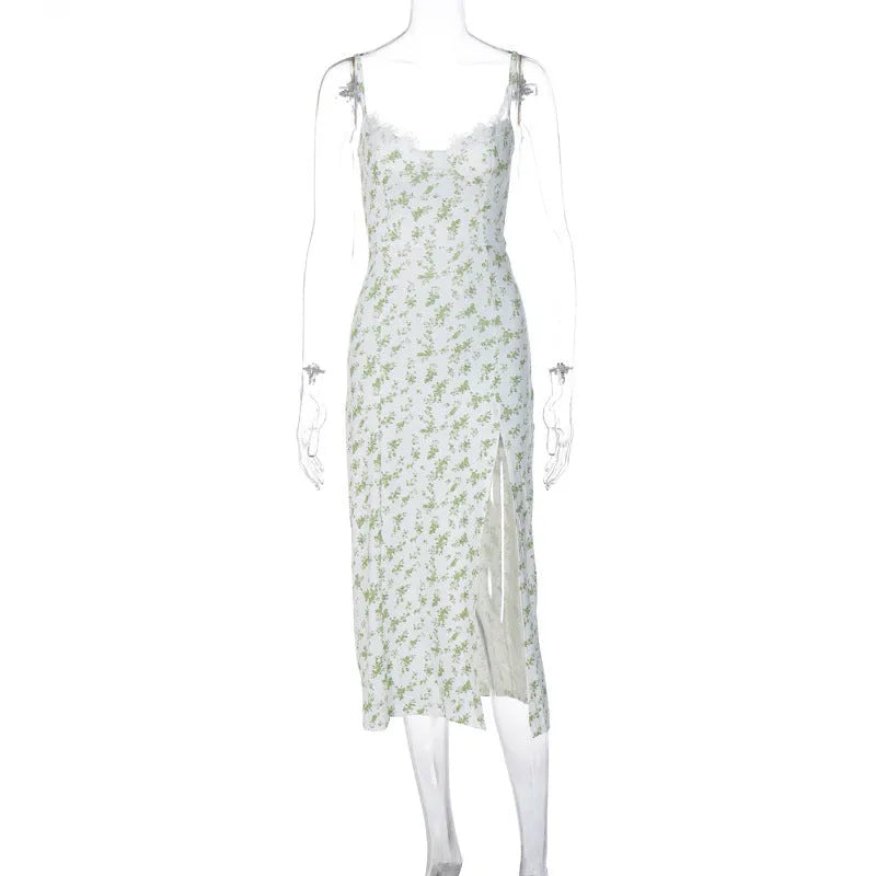 Women's long summer dress with lace flower print, suspender straps, and a high-leg slit.