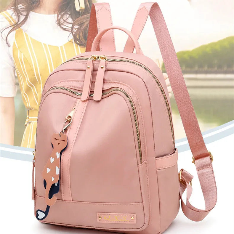 Women's black nylon casual backpack with double shoulder straps showing internal compartments and waterproof features