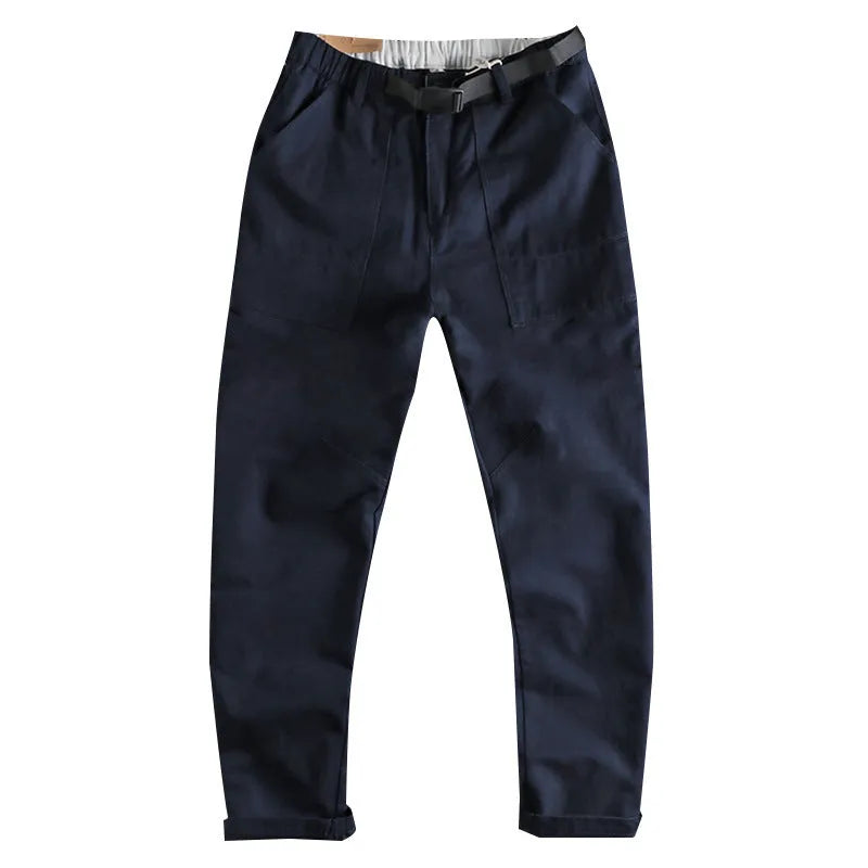 Men's khaki cotton work trousers with three-dimensional cutting and a silver N I buckle belt on the waist.