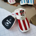 Four blue cloth dog shoes with zipper closures, showing non-slip soles, laid out on a white surface.