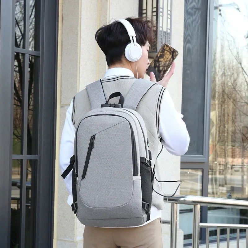Grey Oxford cloth computer backpack with 35 litre capacity showing front compartment and shoulder straps