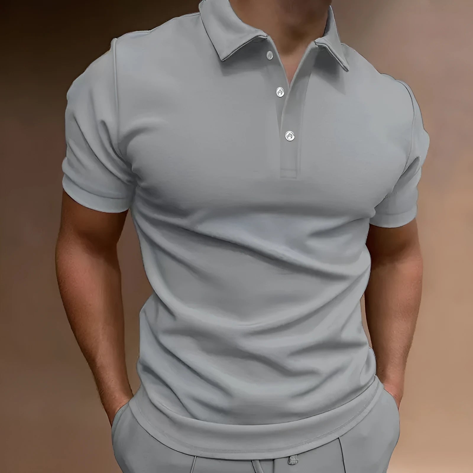 Man wearing a grey loose fit cotton blend short sleeve t-shirt for casual leisure wear.