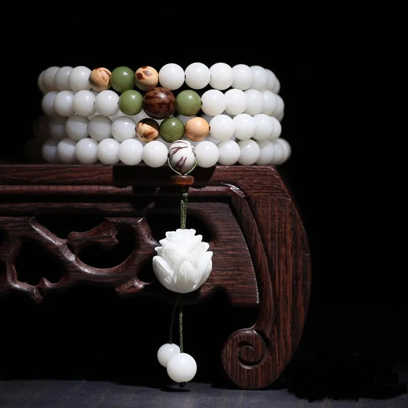 White jade Bodhi seed bracelet with 6x8mm beads showing multiple decorative style options