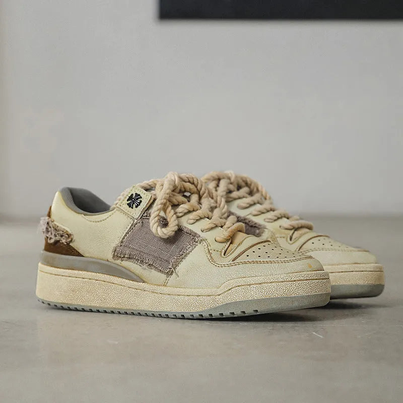 Beige low-top casual skate shoes with lace-up front and flat rubber sole.