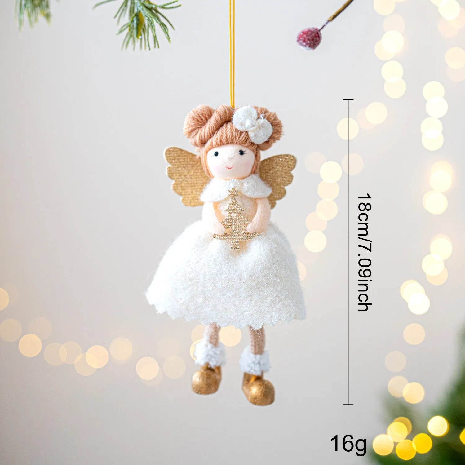 Pink and white cloth angel wings plush pendant Christmas ornament hanging against festive background