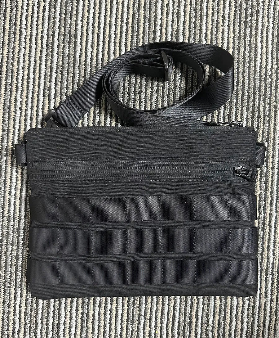 Black Oxford cloth military utility bag measuring 18 by 3.5 centimetres
